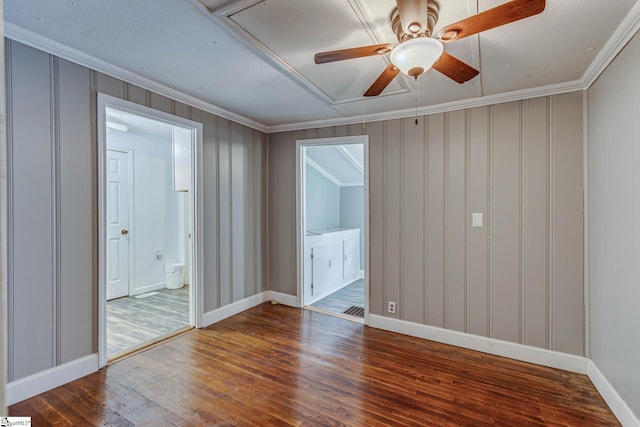 spare room featuring crown molding, ceiling fan, and dark wood-type flooring