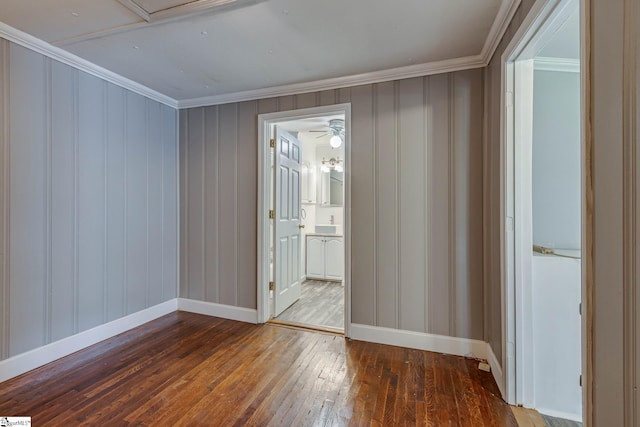 unfurnished room featuring hardwood / wood-style flooring and crown molding