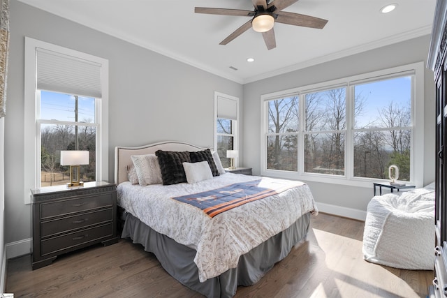 bedroom with hardwood / wood-style flooring, ceiling fan, and crown molding