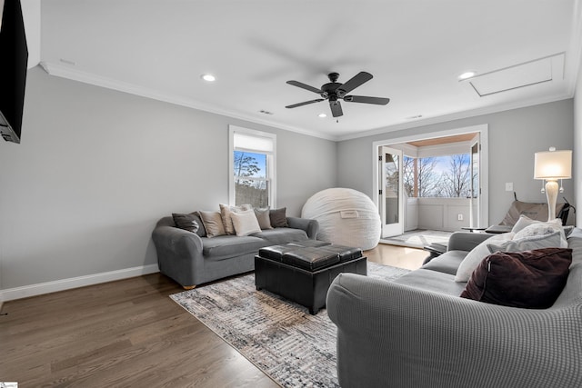 living room featuring ceiling fan, crown molding, plenty of natural light, and wood-type flooring