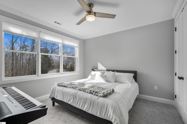 carpeted bedroom featuring crown molding and ceiling fan