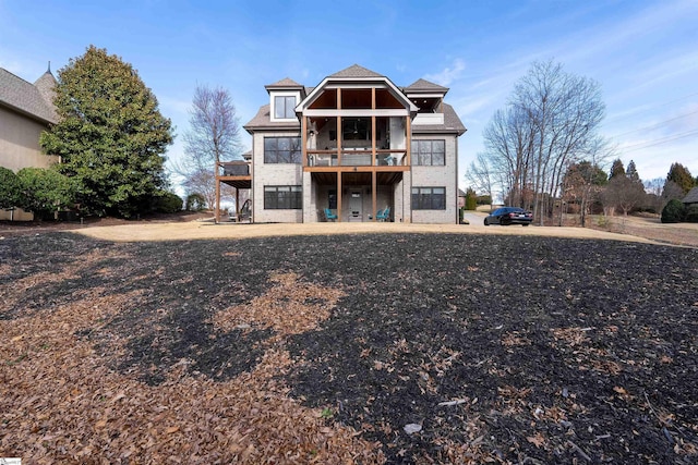 rear view of house featuring a wooden deck