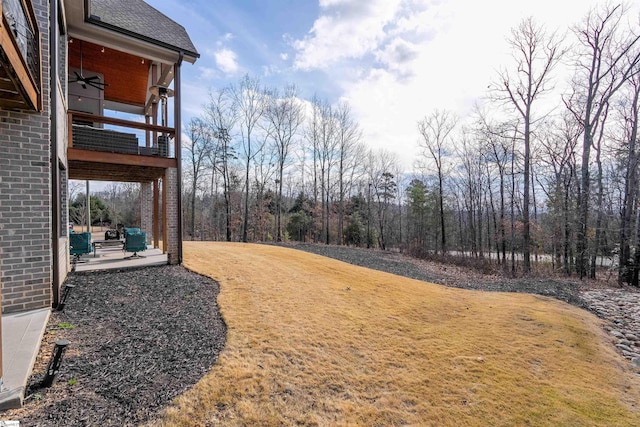 view of yard with ceiling fan and a patio area