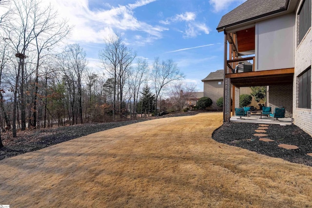 view of yard with an outdoor living space and a patio