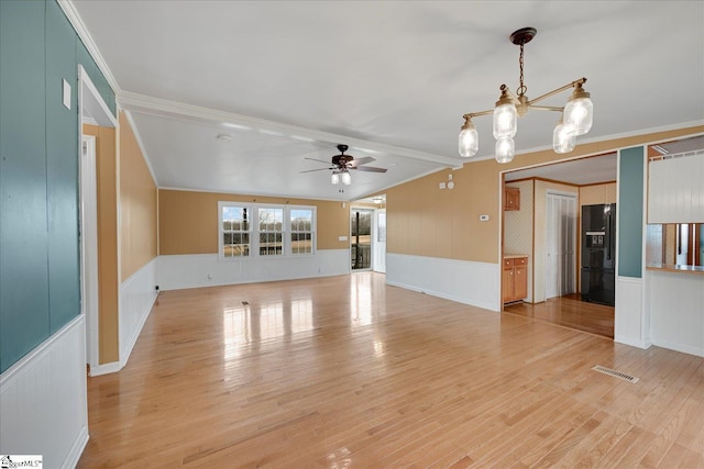 empty room featuring hardwood / wood-style flooring, ceiling fan with notable chandelier, and ornamental molding