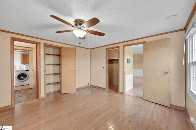 unfurnished bedroom featuring ornamental molding, washer / dryer, light hardwood / wood-style flooring, and a textured ceiling