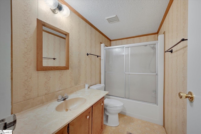 full bathroom featuring toilet, crown molding, bath / shower combo with glass door, a textured ceiling, and vanity