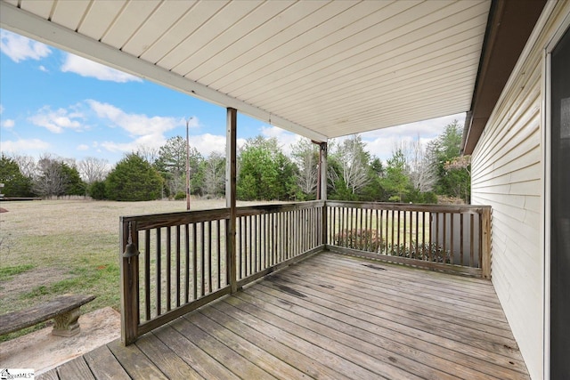 wooden deck featuring a yard