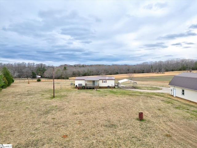 view of yard with a carport and a rural view