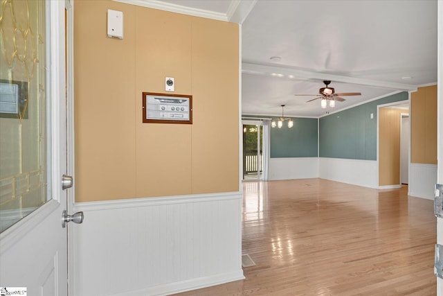 unfurnished room featuring crown molding, light hardwood / wood-style floors, and ceiling fan