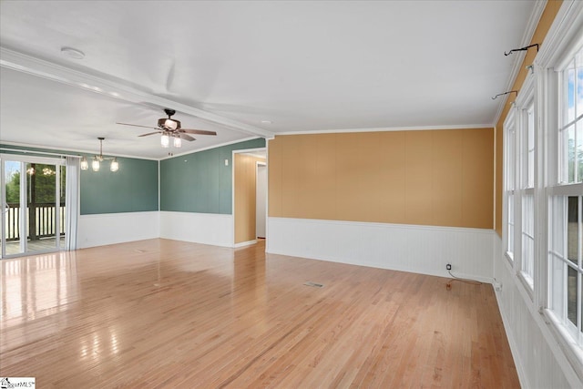 unfurnished room featuring ceiling fan with notable chandelier, ornamental molding, and light hardwood / wood-style floors