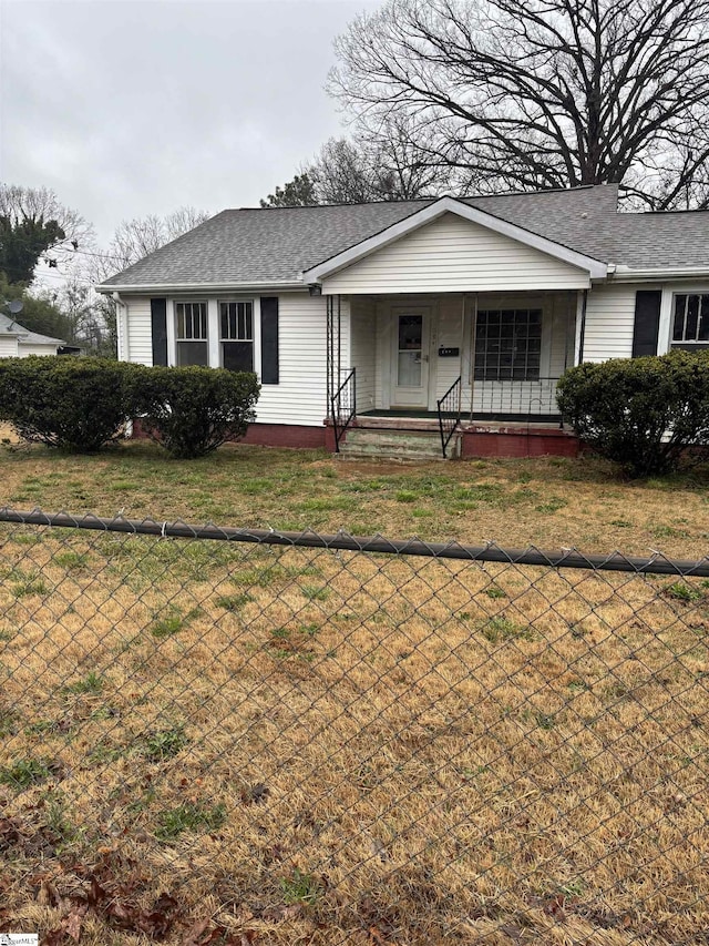 ranch-style house with a porch and a front lawn