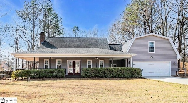 view of front of house with a garage, a porch, and a front lawn