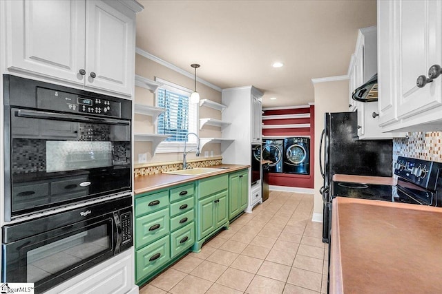 kitchen featuring decorative light fixtures, sink, white cabinets, green cabinets, and washer and clothes dryer