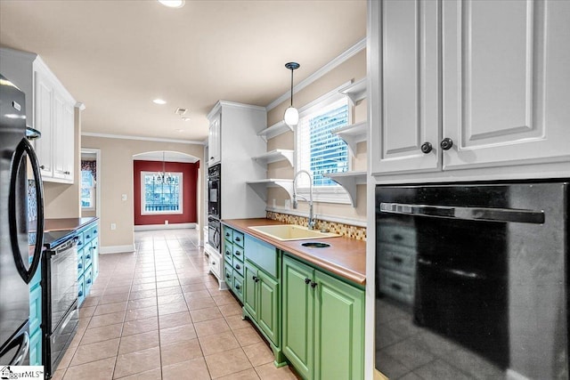 kitchen with white cabinetry, green cabinets, oven, and sink