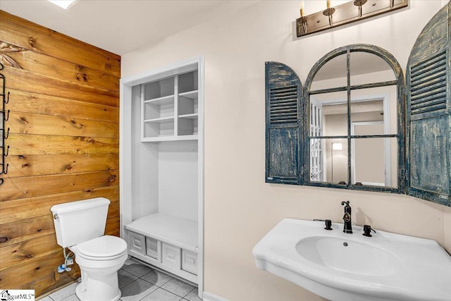 bathroom with sink, toilet, and tile patterned flooring