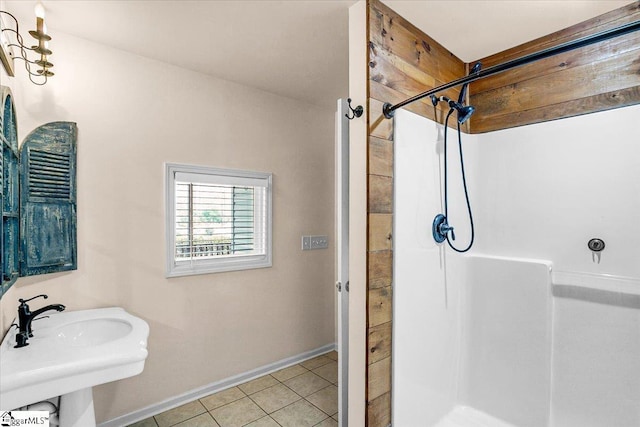 bathroom with sink, tile patterned flooring, and a shower