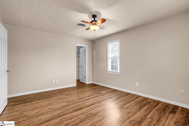 unfurnished bedroom featuring ceiling fan, wood-type flooring, a closet, and a textured ceiling