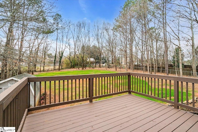 wooden terrace featuring a yard