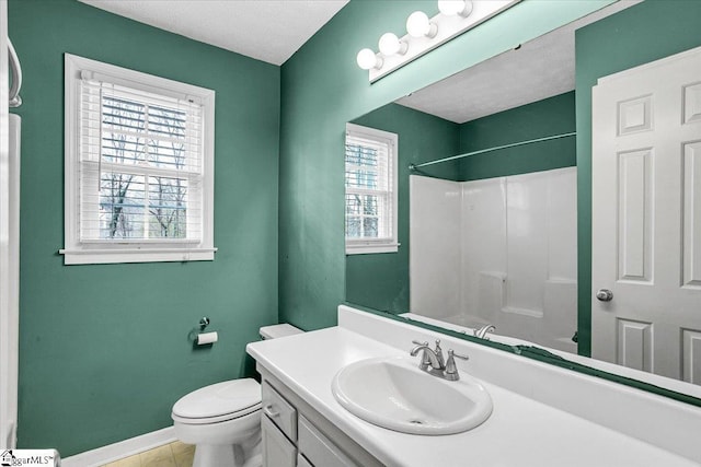 bathroom with a shower, vanity, a textured ceiling, and toilet