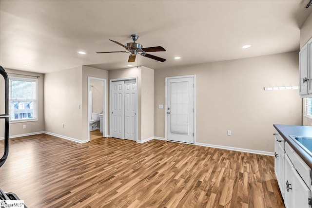 interior space with sink, light hardwood / wood-style flooring, and ceiling fan