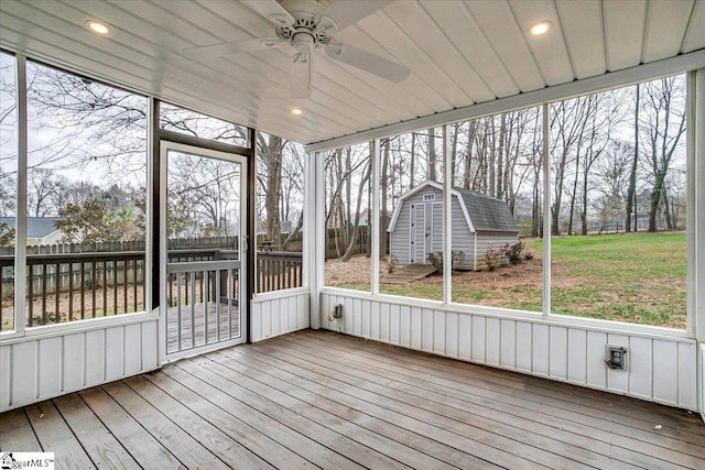 unfurnished sunroom with ceiling fan