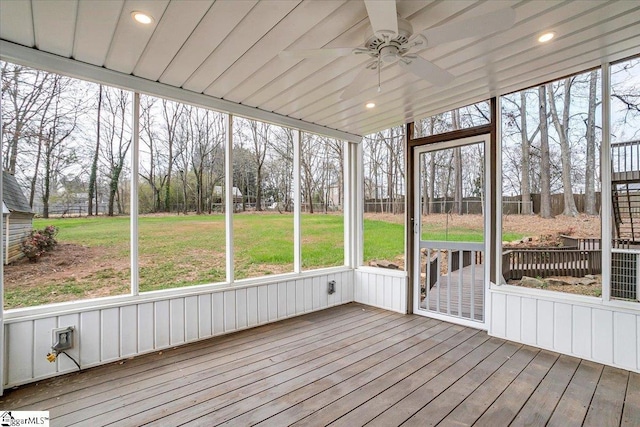 unfurnished sunroom with ceiling fan and plenty of natural light