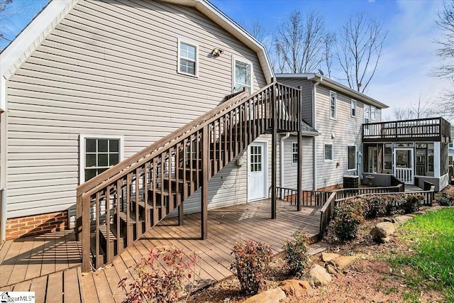 rear view of house featuring cooling unit and a deck