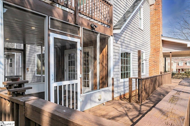 exterior space featuring a sunroom and a deck