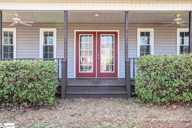 entrance to property with french doors, ceiling fan, and a porch