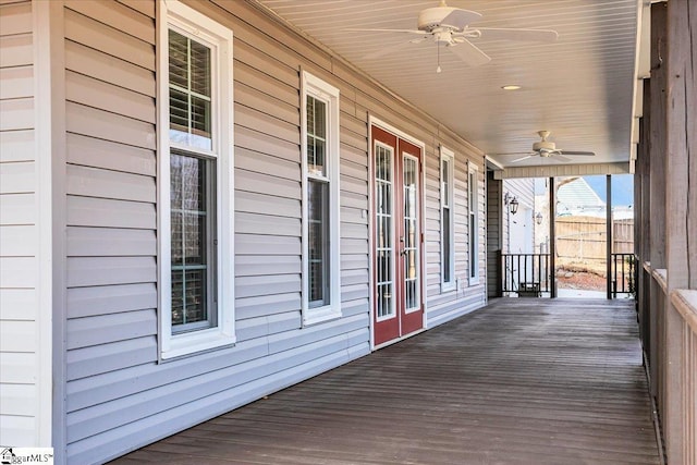 wooden terrace featuring ceiling fan and covered porch