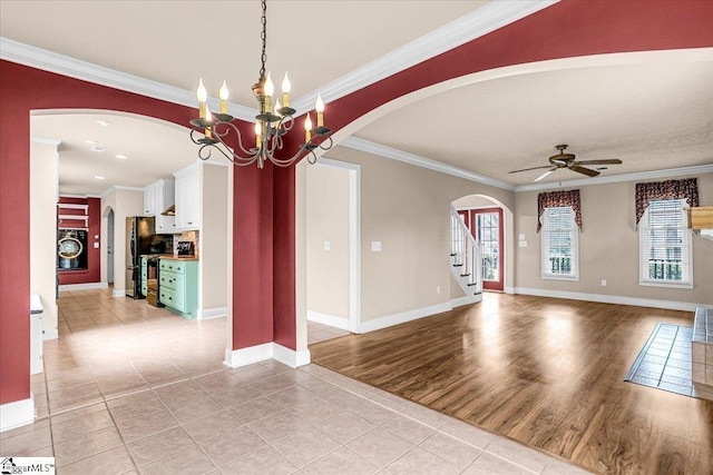 interior space with ornamental molding, washer / clothes dryer, ceiling fan with notable chandelier, and light hardwood / wood-style flooring