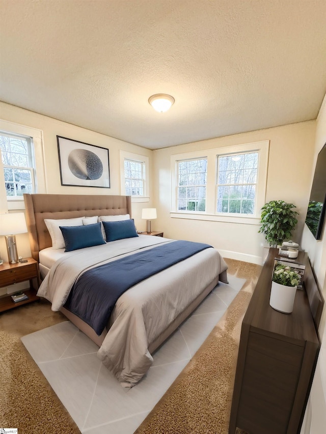 carpeted bedroom with a textured ceiling