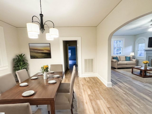 dining space with an inviting chandelier and light wood-type flooring