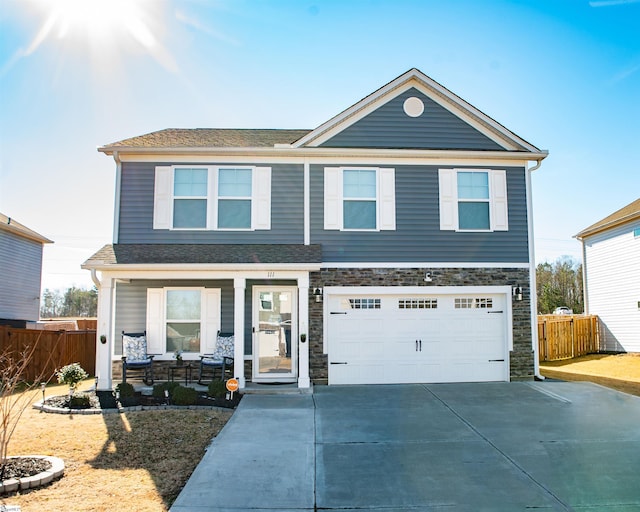 view of front of property featuring a garage and a porch