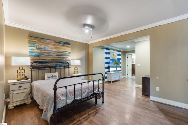 bedroom featuring crown molding, hardwood / wood-style flooring, and ceiling fan