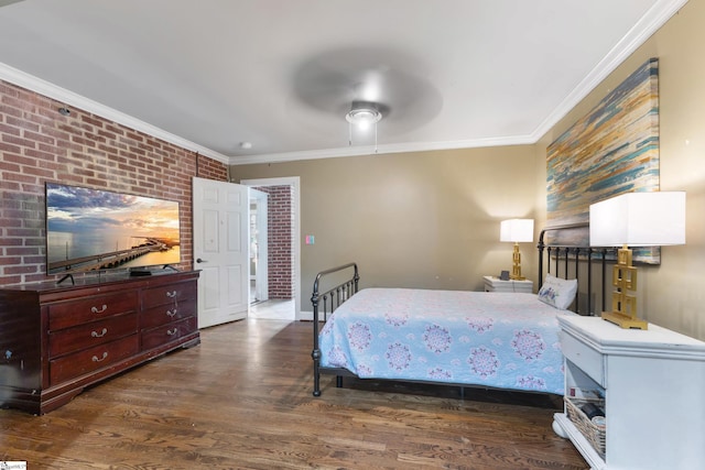 bedroom with crown molding, ceiling fan, brick wall, and dark hardwood / wood-style flooring