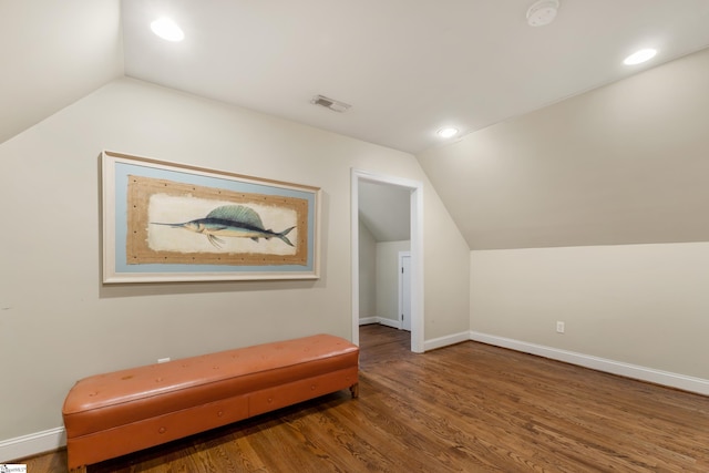 additional living space featuring hardwood / wood-style flooring and vaulted ceiling