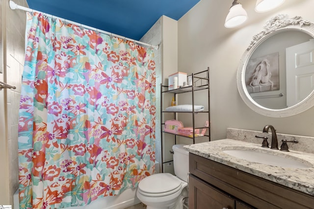 full bathroom featuring shower / bath combination with curtain, vanity, and toilet