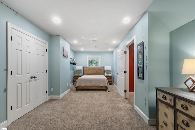 bedroom with ceiling fan and light carpet