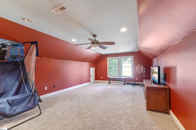 interior space with light carpet, vaulted ceiling, and ceiling fan