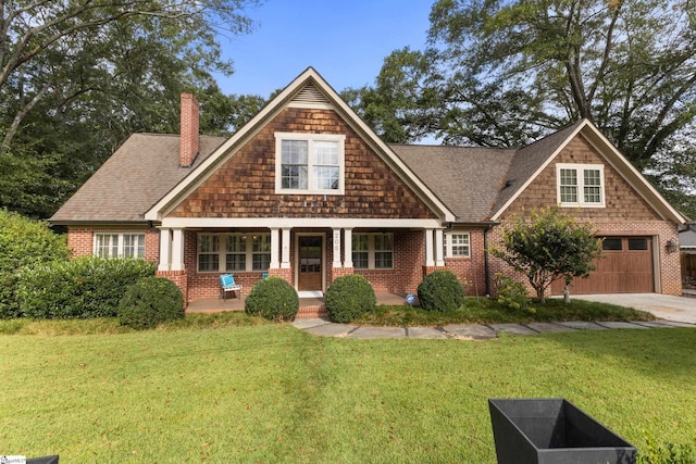 craftsman-style home featuring a porch, a garage, and a front yard