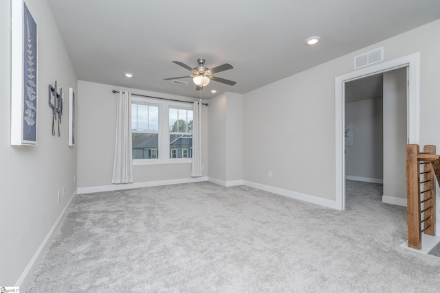 carpeted empty room featuring ceiling fan