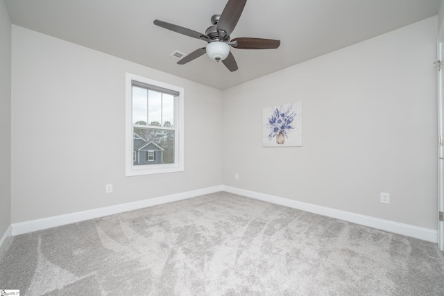 spare room featuring light carpet and ceiling fan