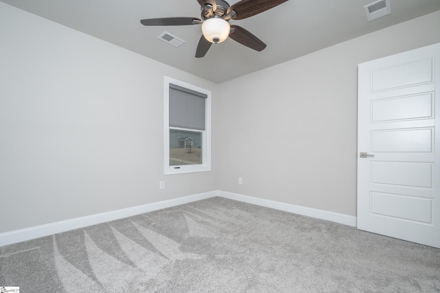 empty room featuring ceiling fan and carpet