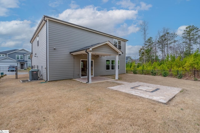 back of property featuring a lawn, central air condition unit, and a patio area