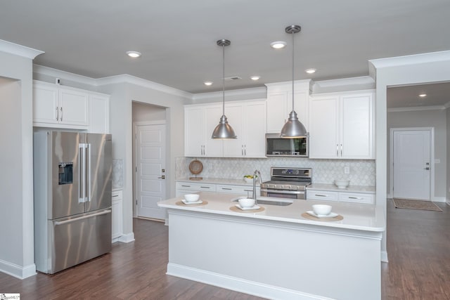 kitchen featuring pendant lighting, white cabinetry, stainless steel appliances, and an island with sink