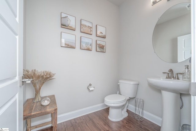 bathroom featuring sink, hardwood / wood-style flooring, and toilet