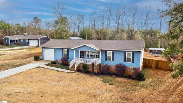 ranch-style house featuring a garage, covered porch, and a front lawn