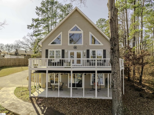 rear view of property with a deck and a patio area